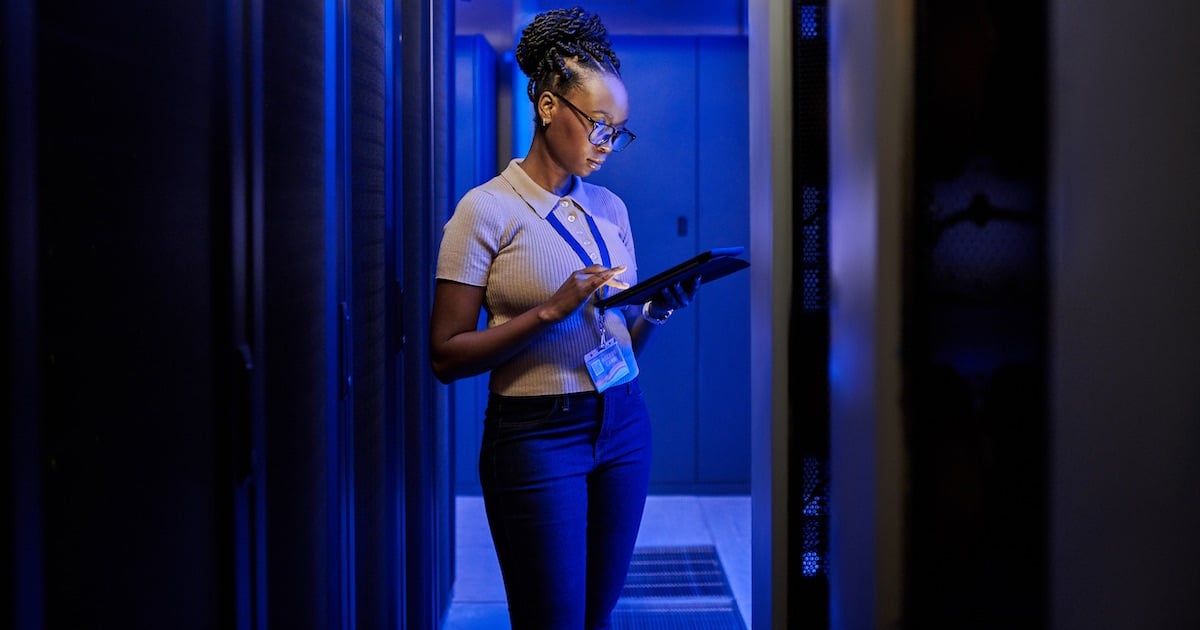 woman analyzing cloud dashboard in computer server room