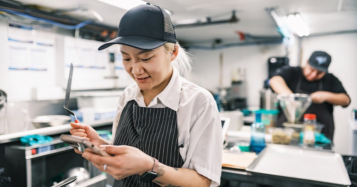 two restaurant employees use their Sensing as a Service solution to increase operational efficiency