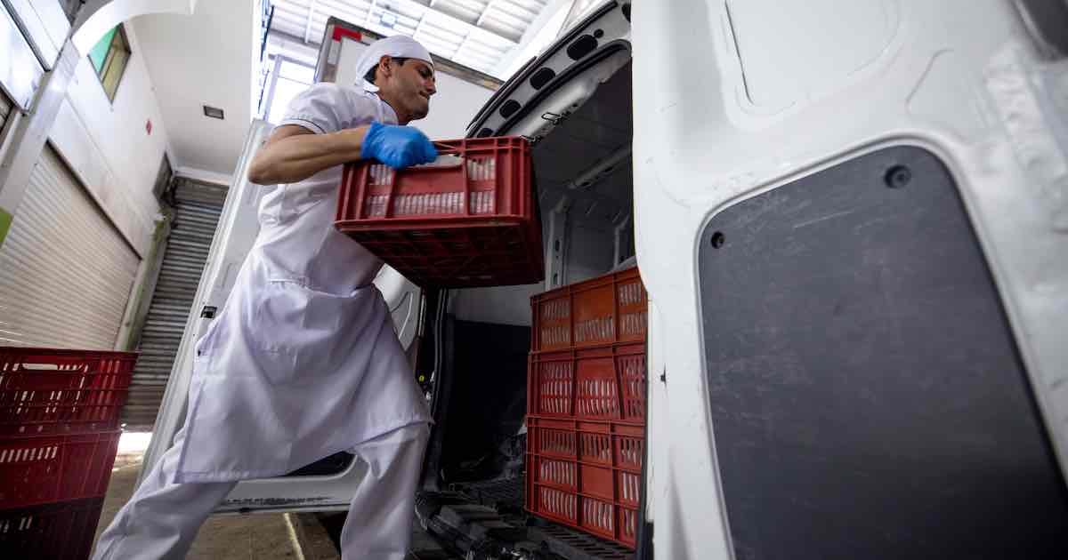 person loading meat into a vehicle