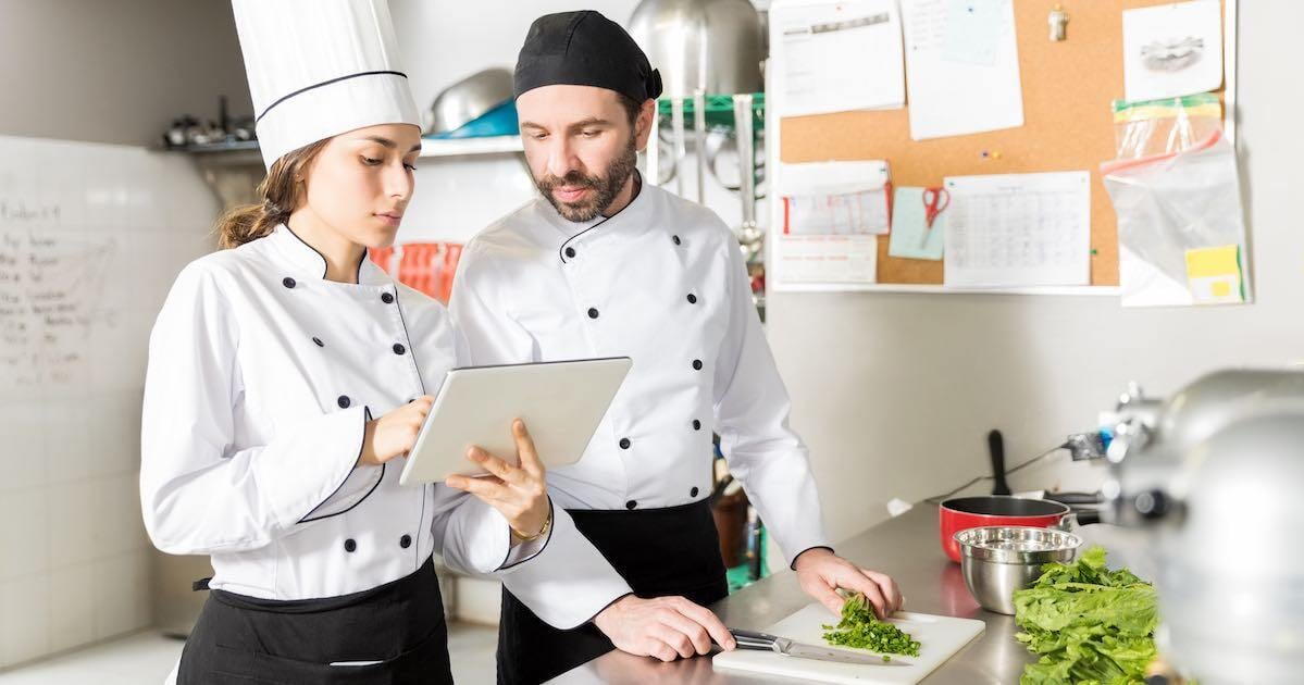 chef and her line cook using digital task management tools