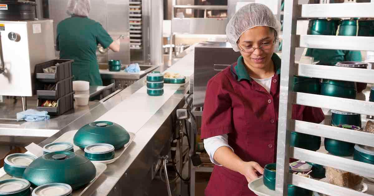 hospital cafeteria employees preparing meals for patients