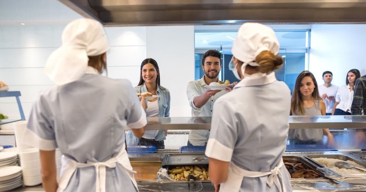 school cafeteria staff serving meals