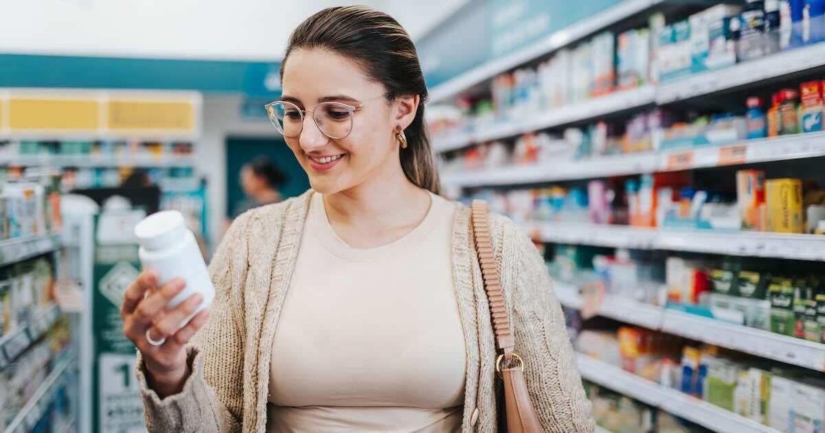woman looking at pharmacy medication in the store