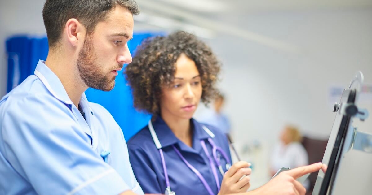 healthcare workers using a digital tablet