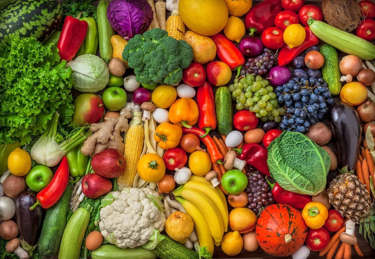 Assorted fruit and vegetables including apples bananas peppers and cabbage.