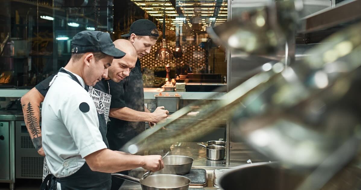 restaurant employees making food in the back of house