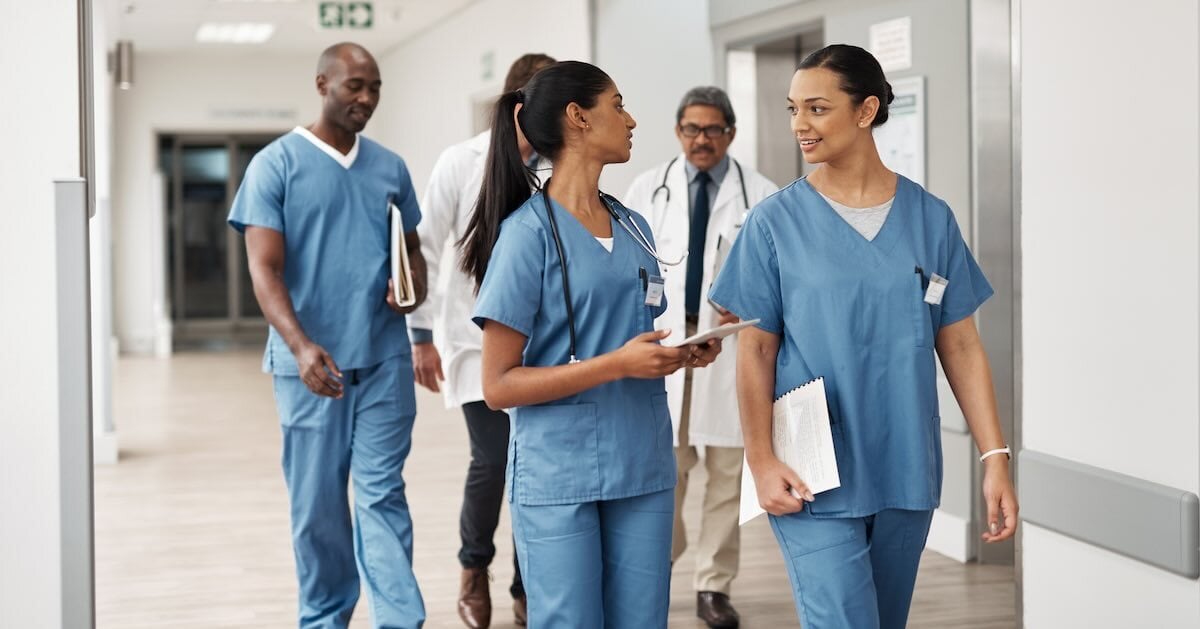 healthcare employees walking down a hospital hallway